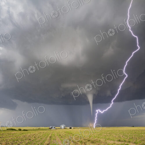 Fully Condensed Tornado with a lightning bolt from the clouds reaching the ground,… Fully Condensed Tornado with a lightning bolt from the clouds reaching the ground,…