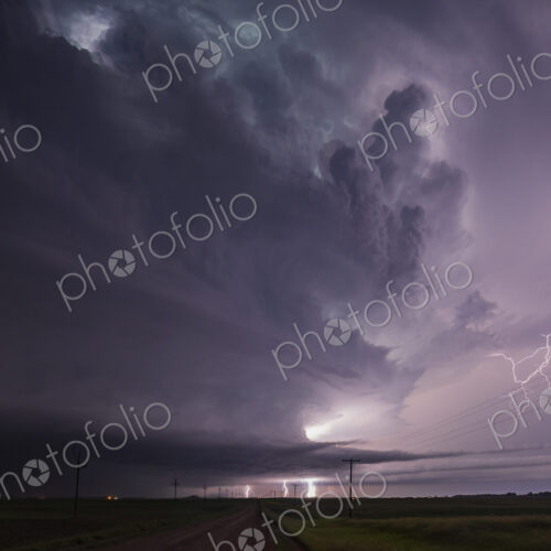 Fully Developed Wedge Tornado on the Ground after Sunset with Lightning in the Supercell