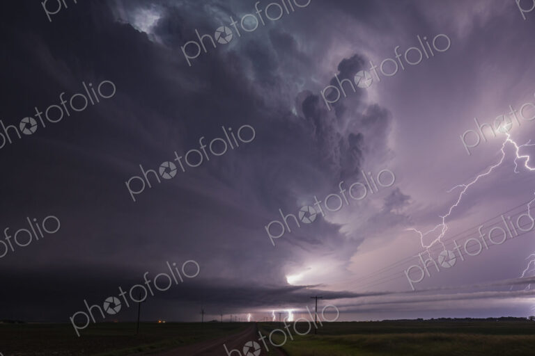 Fully Developed Wedge Tornado on the Ground after Sunset with Lightning in the Supercell