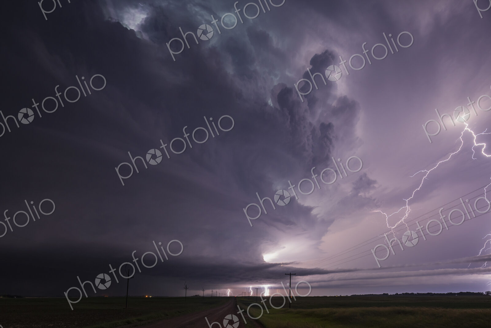Fully Developed Wedge Tornado on the Ground after Sunset with Lightning in the Supercell