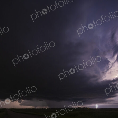 Fully Developed Wedge Tornado on the Ground after Sunset with Lightning in the Supercell
