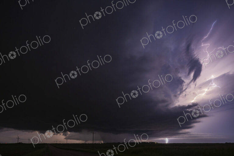 Fully Developed Wedge Tornado on the Ground after Sunset with Lightning in the Supercell