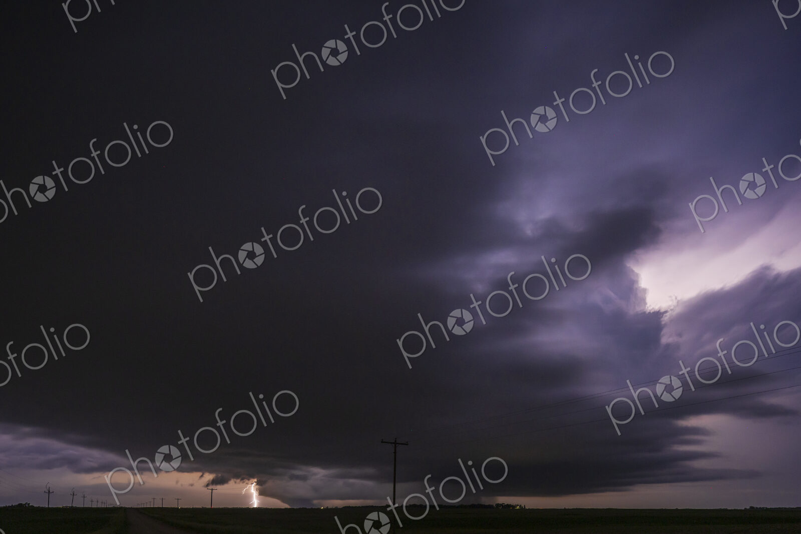 Fully Developed Wedge Tornado on the Ground after Sunset with Lightning in the Supercell