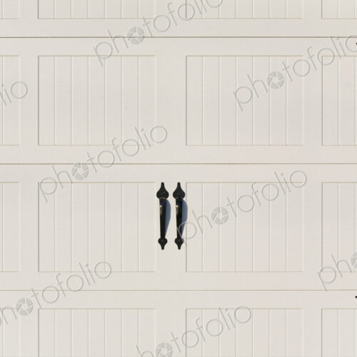 Garage doors, white painted panelled double doors with black metalwork brackets and… Garage doors, white painted panelled double doors with black metalwork brackets and…