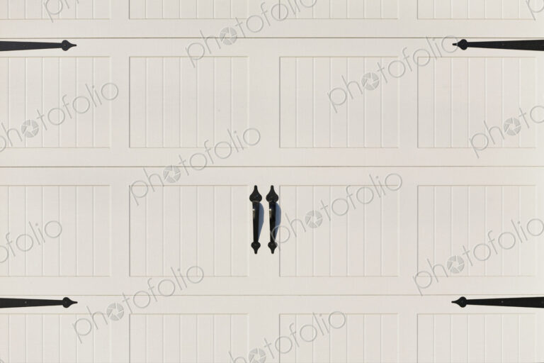Garage doors, white painted panelled double doors with black metalwork brackets and…