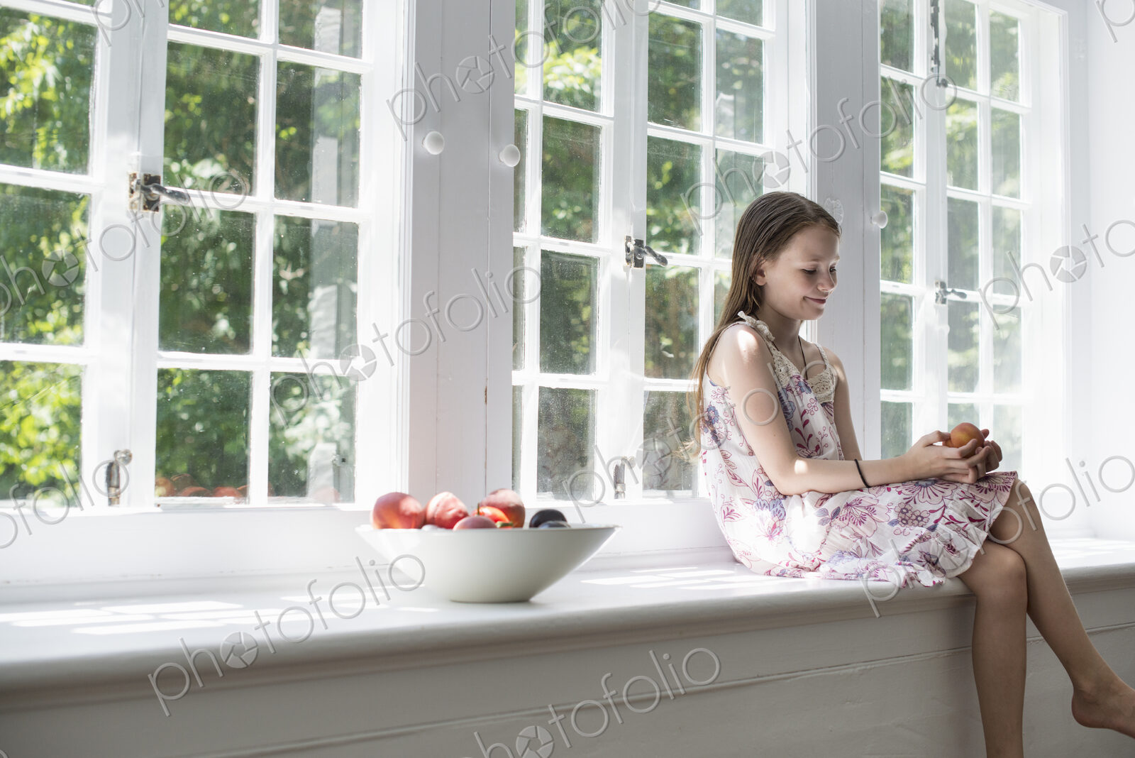 Girl sitting by a window.