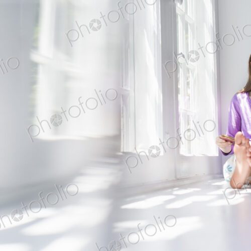 Girl sitting by a window, reading a book. Girl sitting by a window, reading a book.