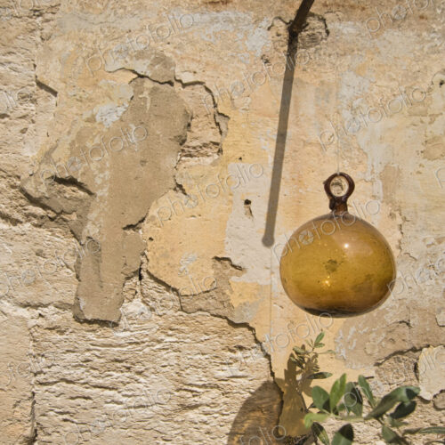 Glass Ball Hanging from Plaster Wall Glass Ball Hanging from Plaster Wall