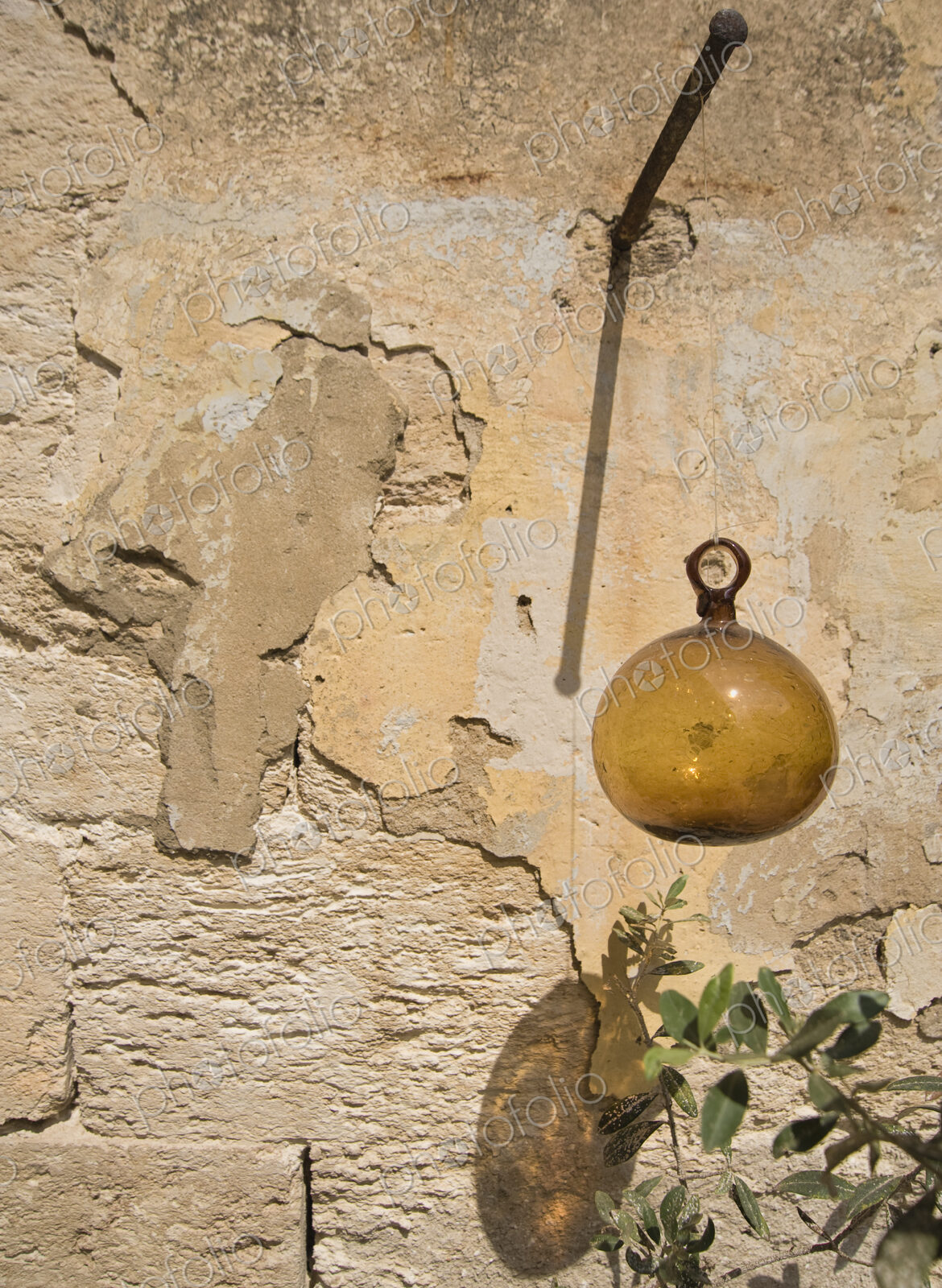 Glass Ball Hanging from Plaster Wall