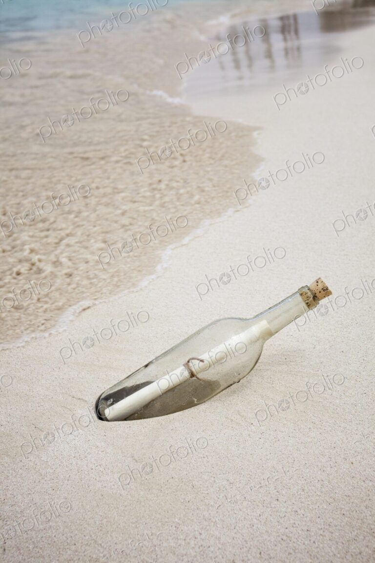 Glass bottle with rolled note washed up on beach in Isla Mujeres, Symbolic image…