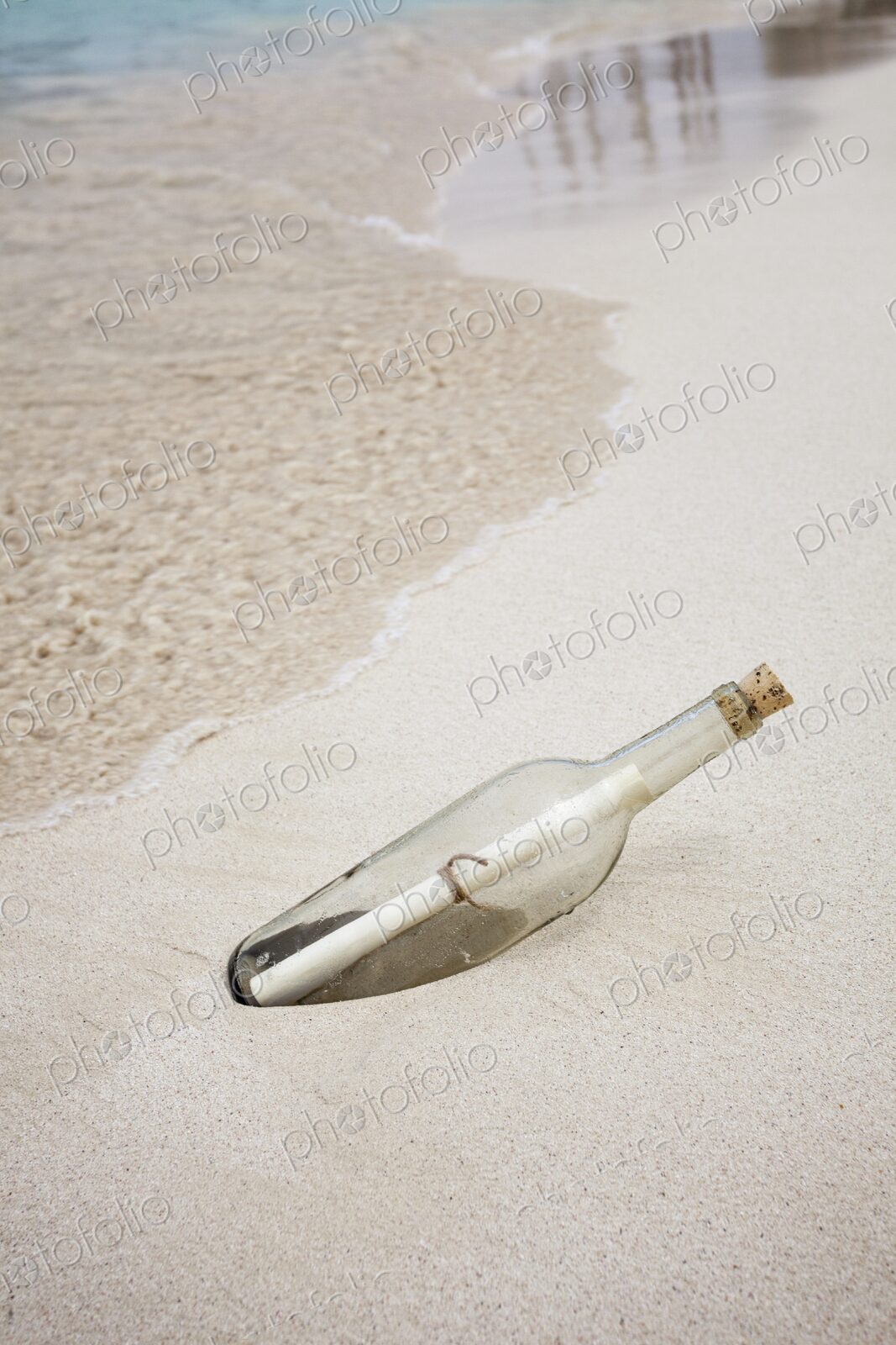 Glass bottle with rolled note washed up on beach in Isla Mujeres, Symbolic image…