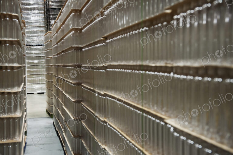 Glass bottles stacked in warehouse