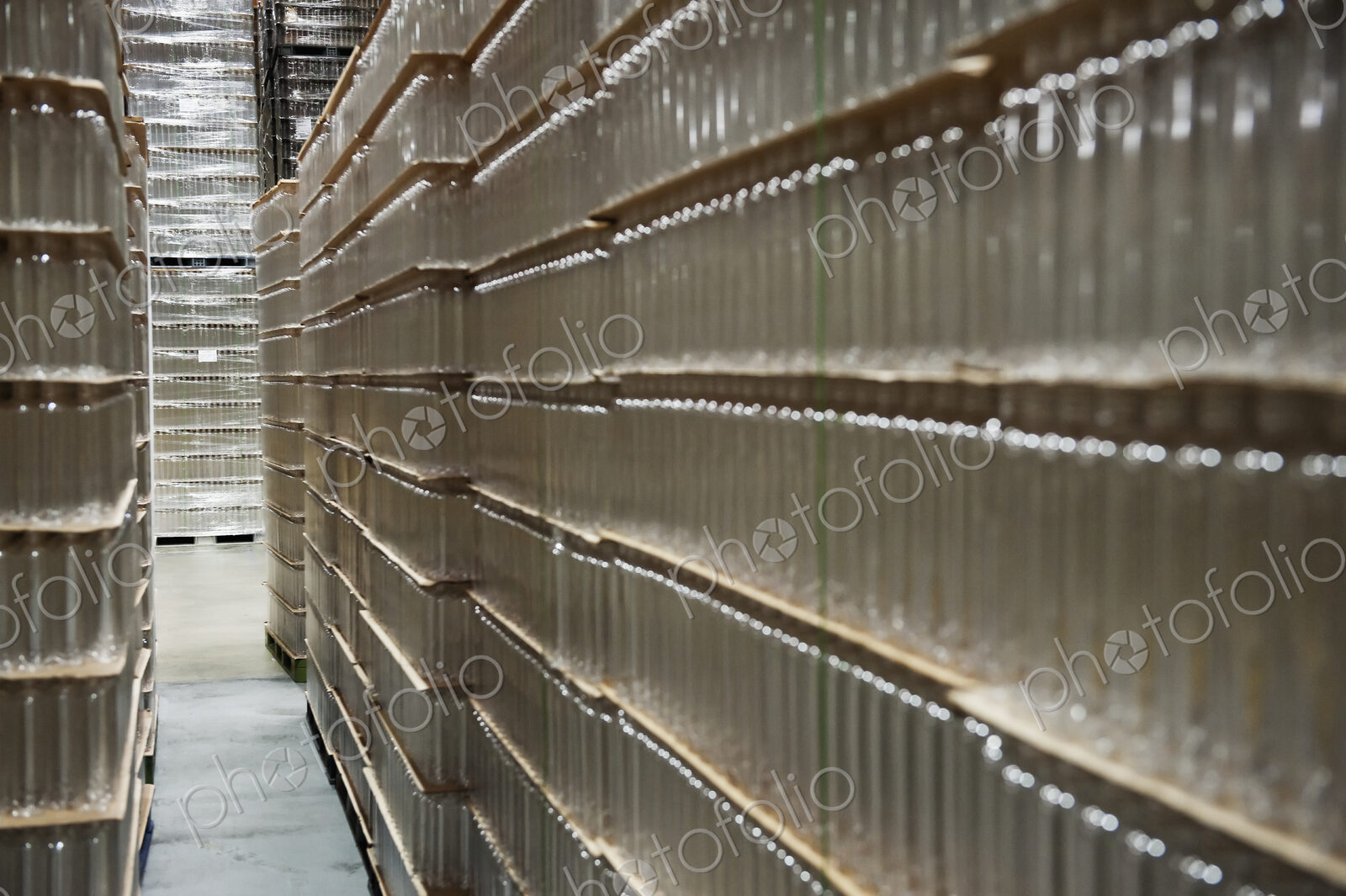 Glass bottles stacked in warehouse