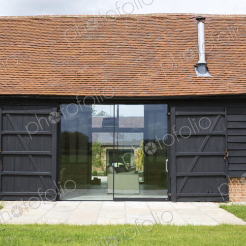 Glass sliding doors of converted barn home Glass sliding doors of converted barn home