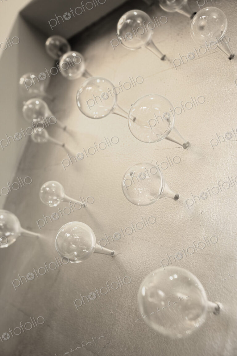 Glass spheres on concrete wall.