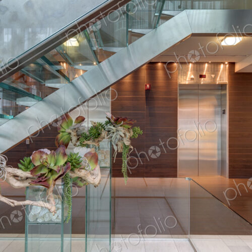 Glass staircase and elevators in hotel lobby
