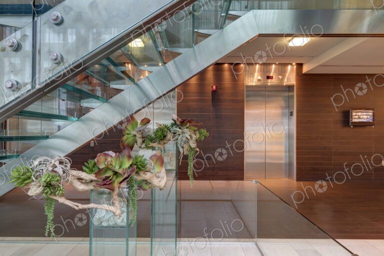 Glass staircase and elevators in hotel lobby