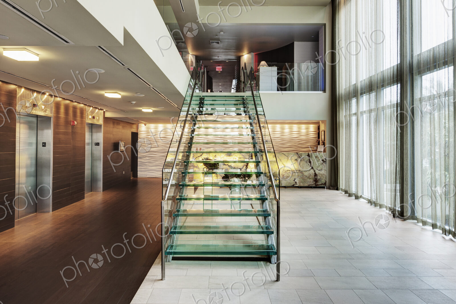 Glass staircase in hotel lobby
