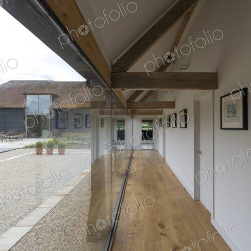 Glass wall and hallway of modern home Glass wall and hallway of modern home
