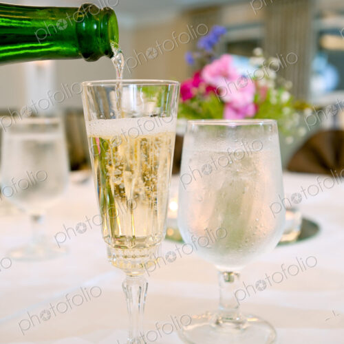 Glasses of champagne and water on table Glasses of champagne and water on table