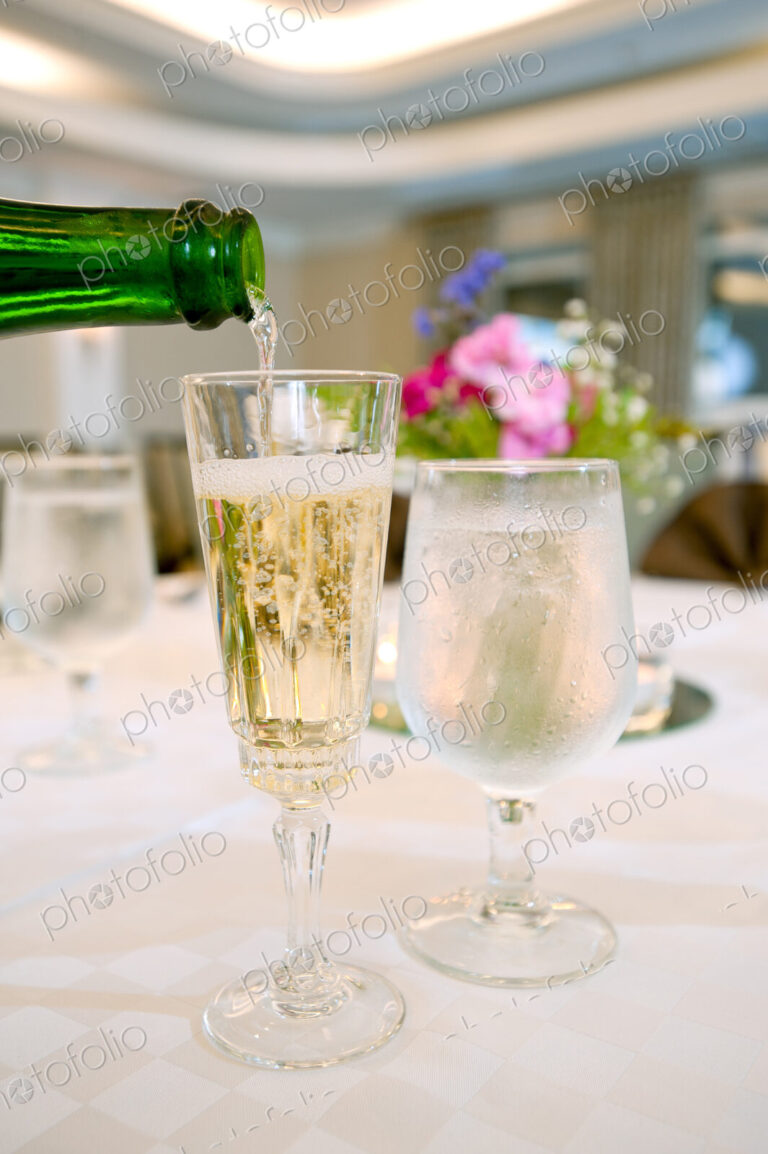 Glasses of champagne and water on table