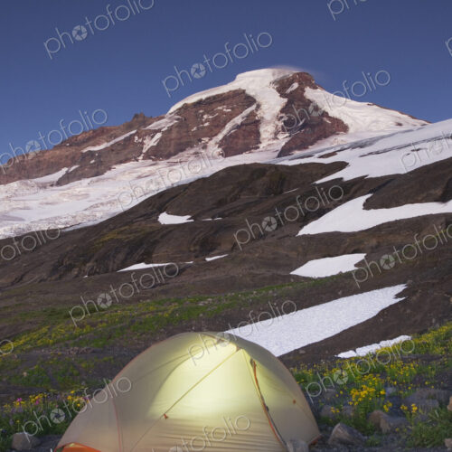 Glowing tent at campsite in remote landscape Glowing tent at campsite in remote landscape