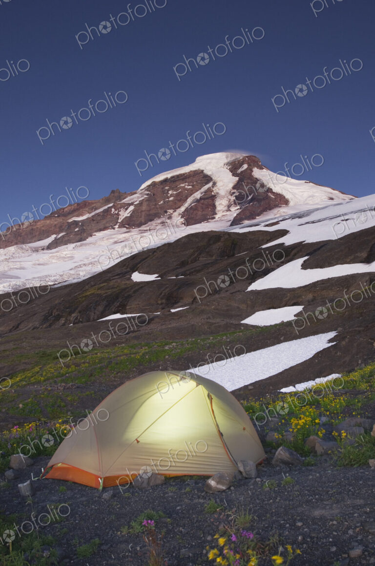 Glowing tent at campsite in remote landscape