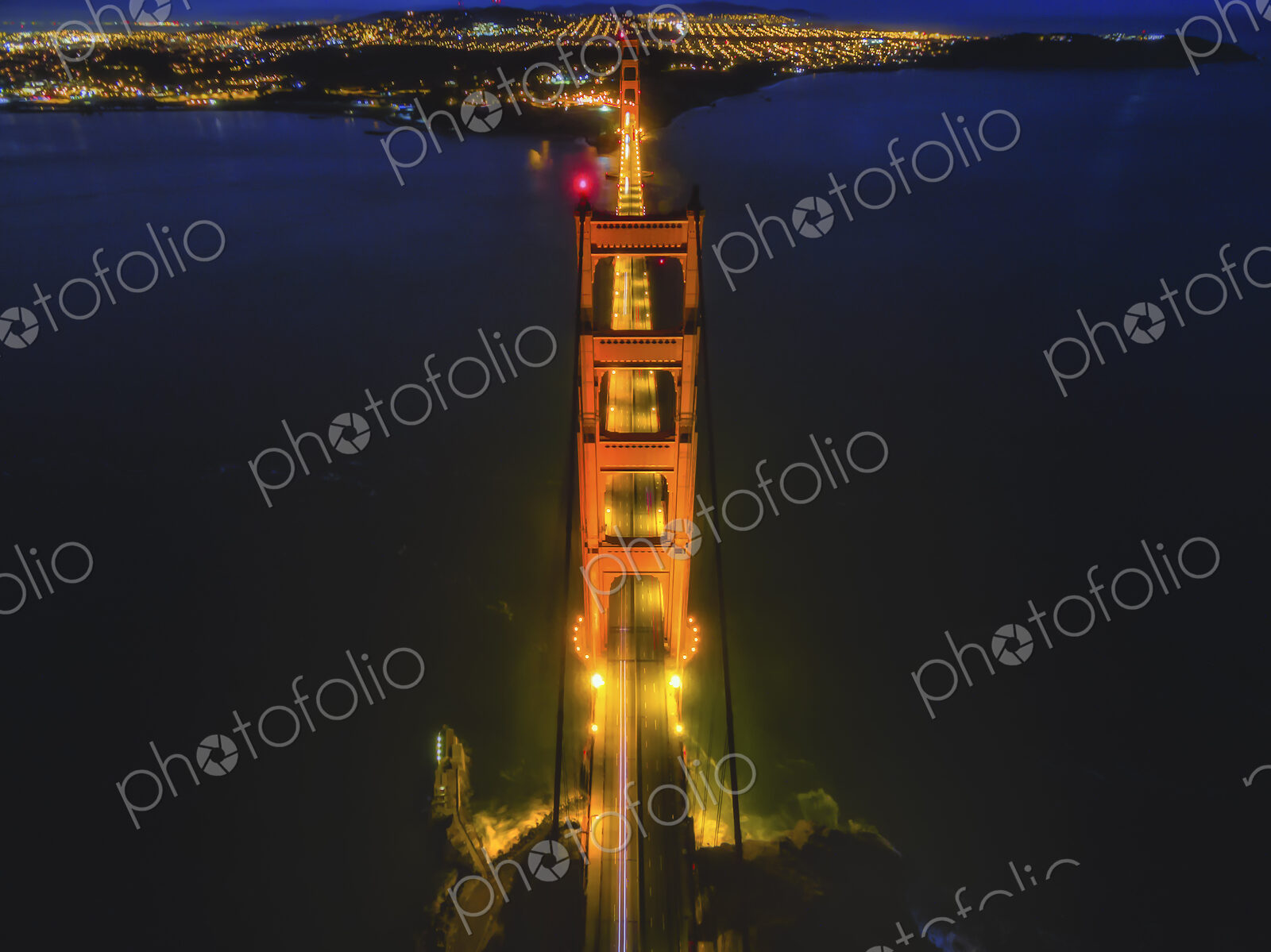 Golden Gate Bridge, aerial view at night. The still waters of San Francisco Bay.