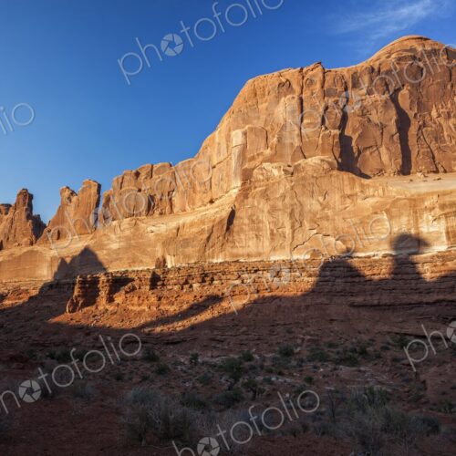 Golden evening light illuminates the towering sandstone cliffs of the Park Avenue rock… Golden evening light illuminates the towering sandstone cliffs of the Park Avenue rock…