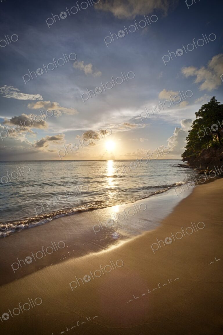 Golden light reflects on the smooth shoreline at Crash Boat Beach in Puerto Rico as…
