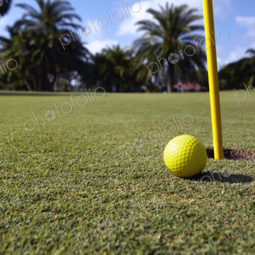 Golf Ball Lying Next to the Hole