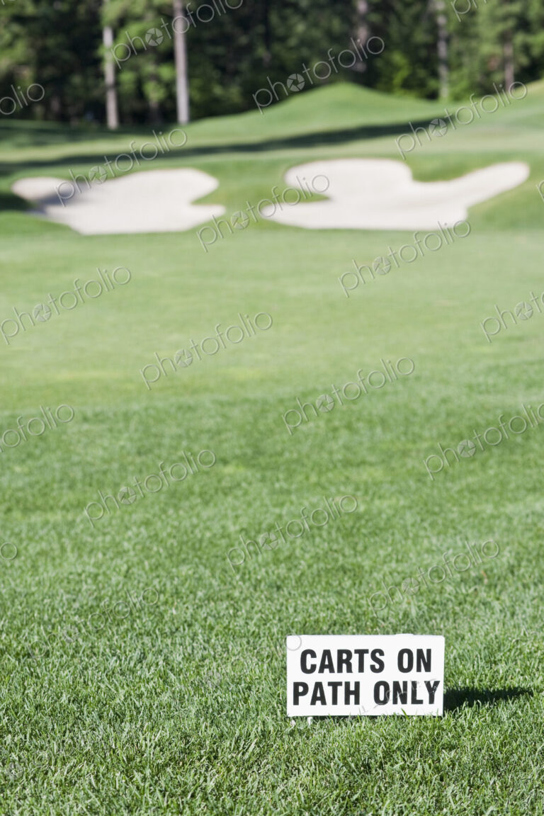 Golf green and sand bunker on golf course.