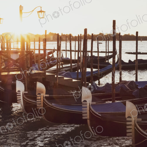 Gondolas moored in the Canale Grande in Venice, Veneto, Italy at sunrise. Gondolas moored in the Canale Grande in Venice, Veneto, Italy at sunrise.