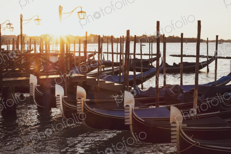 Gondolas moored in the Canale Grande in Venice, Veneto, Italy at sunrise.