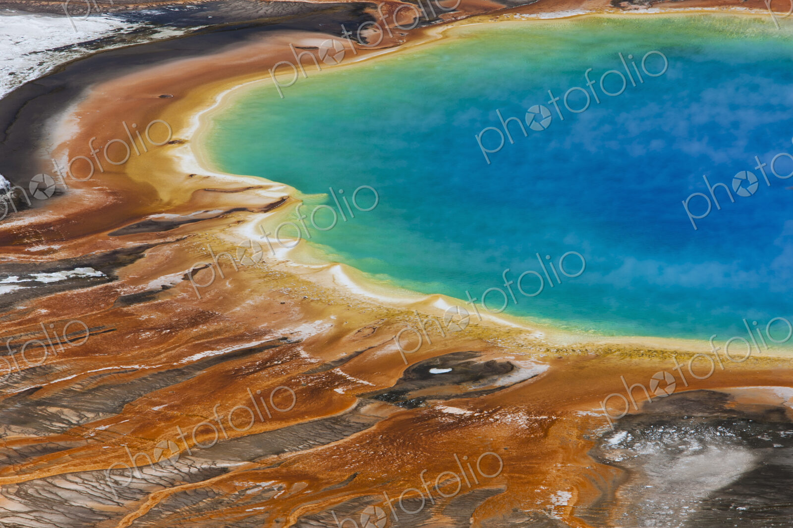 Grand Prismatic Spring, a bright turquoise pool and site of geothermal activity, with…