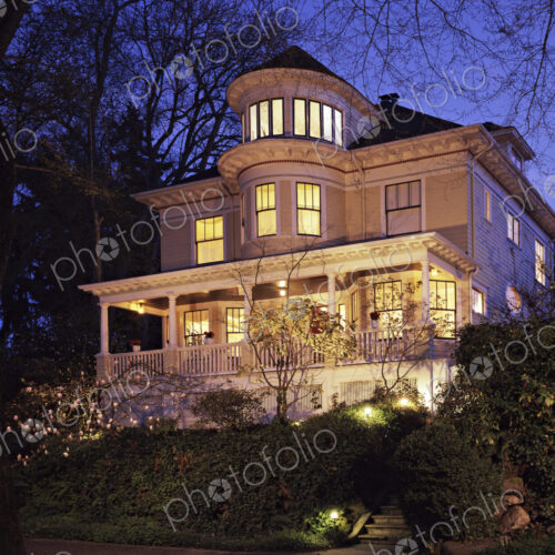 Grand Victorian house lit up at dusk Grand Victorian house lit up at dusk