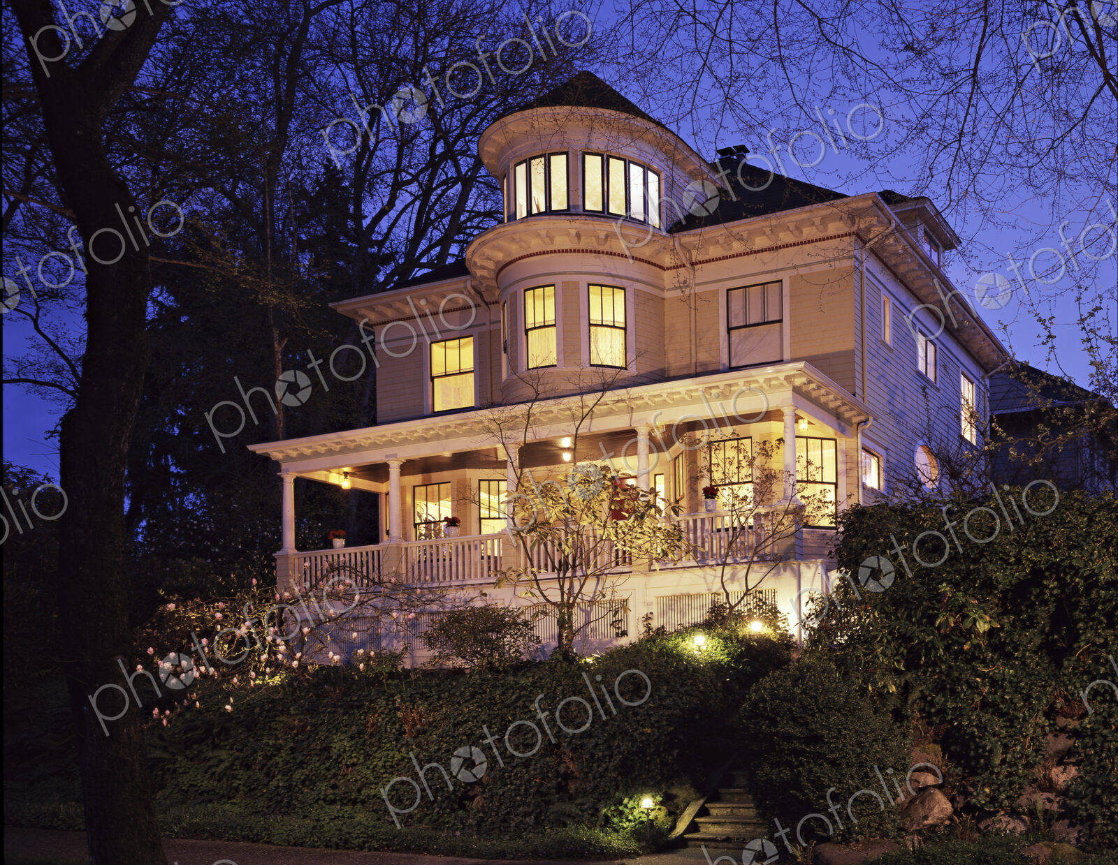 Grand Victorian house lit up at dusk