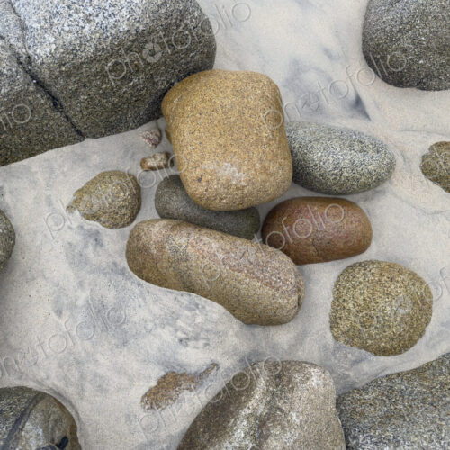 Granite Rocks on the Beach, smoothed by water and sand erosion. Granite Rocks on the Beach, smoothed by water and sand erosion.