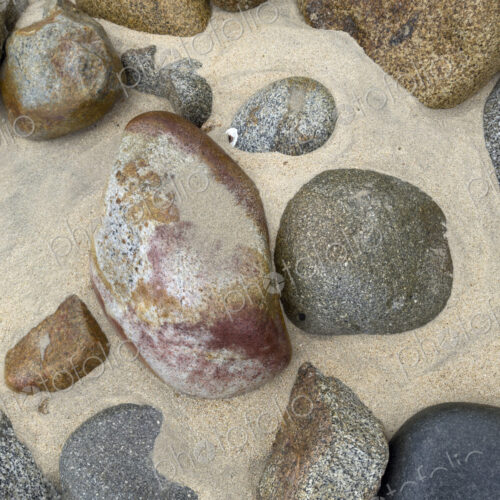Granite Rocks on the Beach, smoothed by water and sand erosion. Granite Rocks on the Beach, smoothed by water and sand erosion.