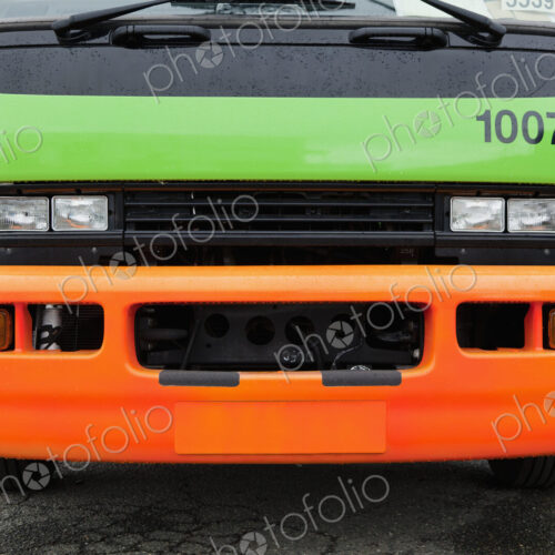 Green And Orange Garbage Truck