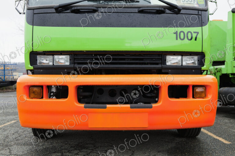 Green And Orange Garbage Truck