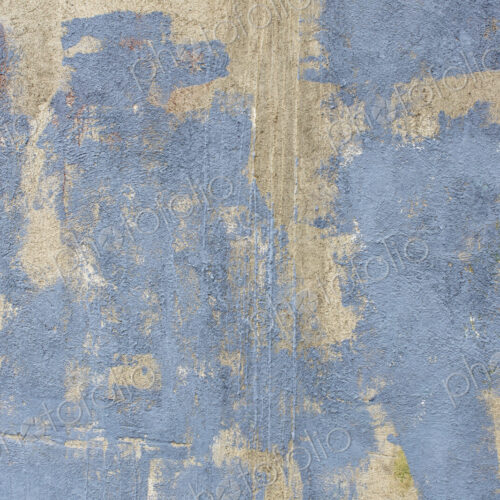 Grey paint covering graffiti tags on concrete wall