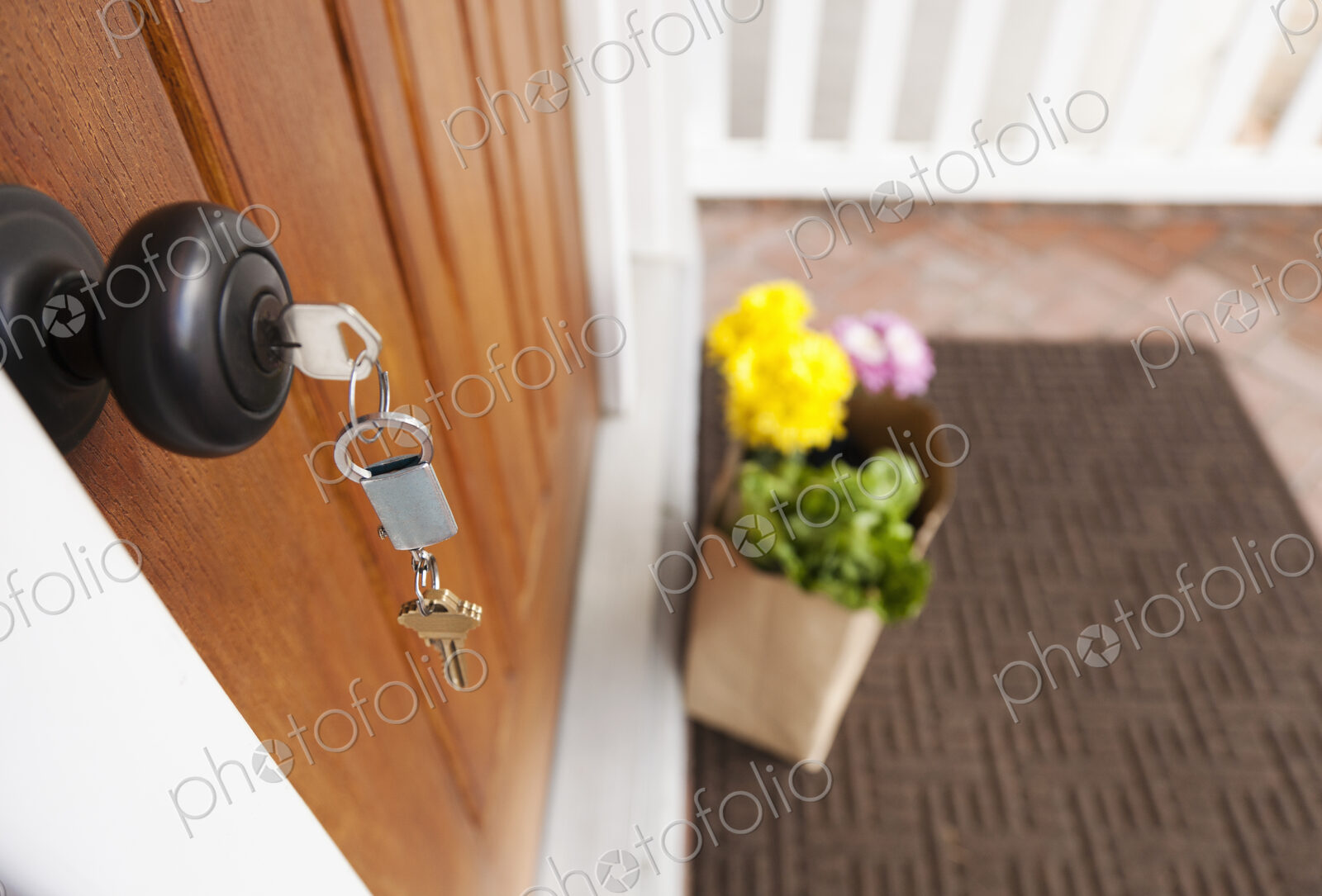 Groceries and keys on front porch of house