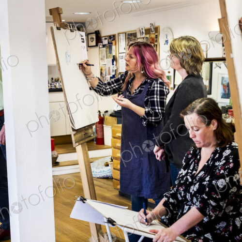 Group of artists standing and sitting at easels, drawing. Group of artists standing and sitting at easels, drawing.