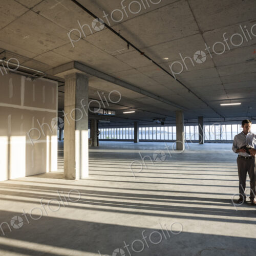 Group of business people looking at a new empty raw office space.