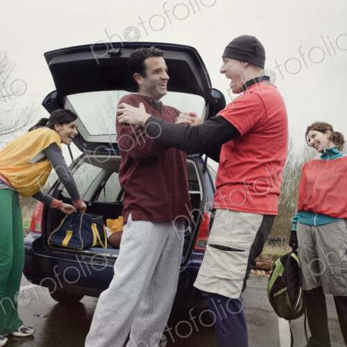 Group of friends unloading gear from a car prior to an American Flag Football game. Group of friends unloading gear from a car prior to an American Flag Football game.