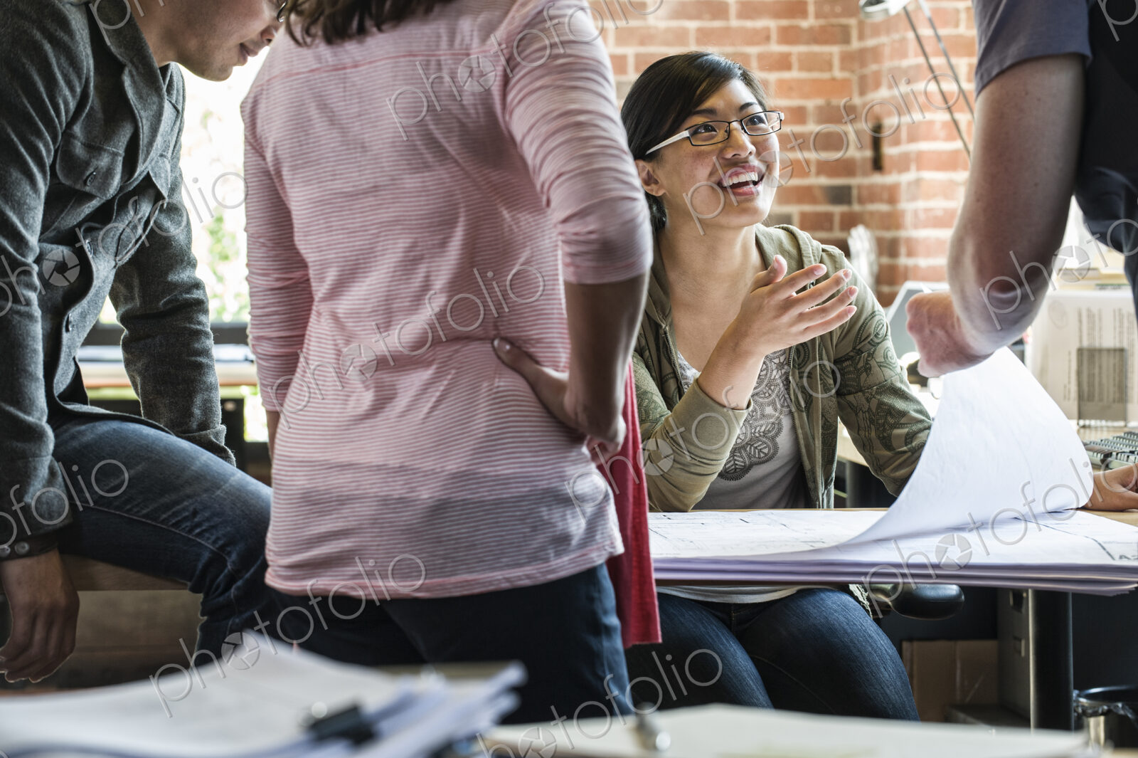 Group of men and women at work at a conference table.