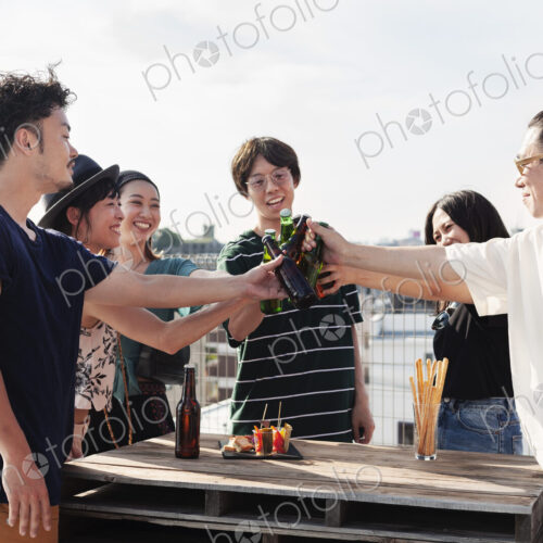Group of young Japanese men and women standing on a rooftop in an urban setting,… Group of young Japanese men and women standing on a rooftop in an urban setting,…