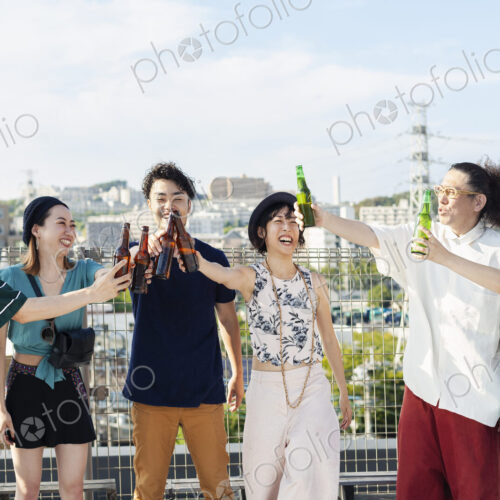 Group of young Japanese men and women standing on a rooftop in an urban setting,… Group of young Japanese men and women standing on a rooftop in an urban setting,…