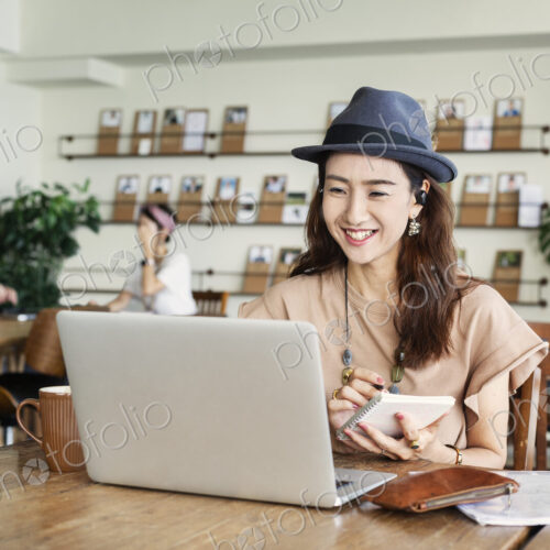 Group of young Japanese professionals working on laptop computers in a co-working space. Group of young Japanese professionals working on laptop computers in a co-working space.